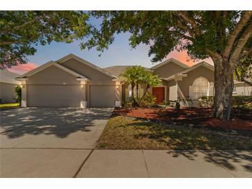 Charming home with a two-car garage and manicured landscaping at 330 Osprey Lakes Cir, Chuluota, FL 32766