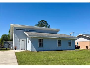 Charming two-story home with a well-manicured lawn and a classic white front door at 38 Juniper Pass Dr, Ocala, FL 34480