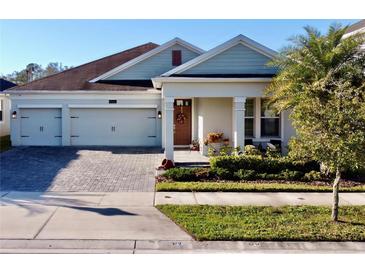 Charming single-story home with a two-car garage, brick-paved driveway, and nicely landscaped front yard at 4562 Tribute Trl, Kissimmee, FL 34746