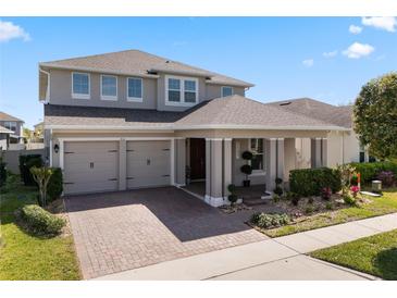 Charming two-story home featuring a well-manicured lawn, covered porch, and a convenient two-car garage at 7131 Desert Mandarin St, Winter Garden, FL 34787