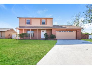 Charming two-story home featuring a well-manicured lawn and a two-car garage at 7355 Rush Ct, Orlando, FL 32818