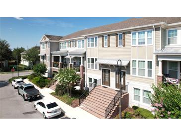 Inviting townhomes feature tidy landscaping, brick stairs, and neutral exteriors in a desirable neighborhood at 869 Taramundi Dr, Oviedo, FL 32765