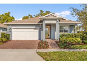 Charming single-story home featuring a brick driveway and well-manicured landscaping at 2413 Park Ridge St, Apopka, FL 32712