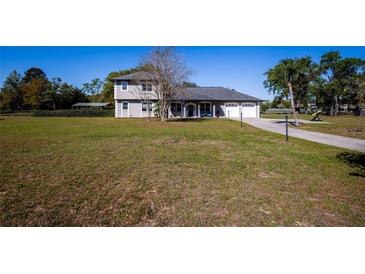 Charming two-story home with landscaped front yard and a two car garage at 36649 Forestdel Dr, Eustis, FL 32736