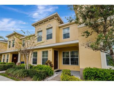 Inviting exterior of a two-story townhome featuring manicured landscaping and a warm, neutral color palette at 5481 Limestone Ln # 5481, Lakeland, FL 33809