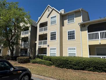 Inviting exterior of a multi-story condo building with well-maintained landscaping and balconies at 1017 S Hiawassee Rd # 3735, Orlando, FL 32835