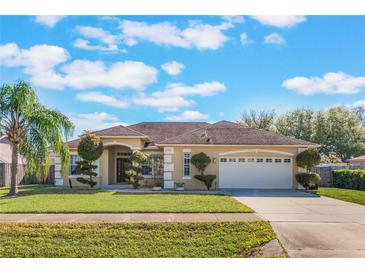 Charming single-story home features a well-manicured lawn, mature trees and a two car garage at 2361 Baker Ave, Orlando, FL 32833