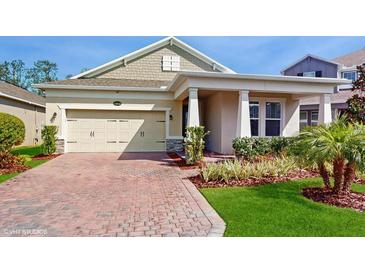 Charming single-story home with well-manicured landscaping and a brick paved driveway at 14345 Wabasso Loop, Winter Garden, FL 34787