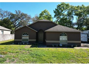 Charming single-story home featuring a well-maintained lawn and complemented by mature trees at 1931 Clarcona Rd, Apopka, FL 32703