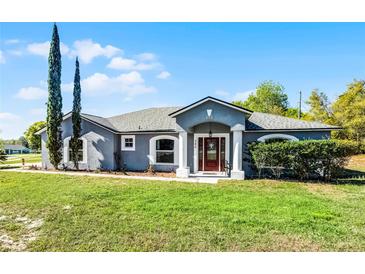 Charming single-story home with manicured lawn and inviting front entrance at 380 Dorset Ave, Deltona, FL 32738