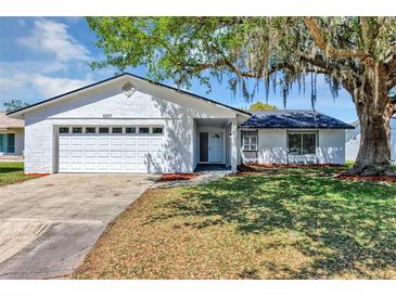 Charming single-story home featuring an attached two-car garage and well-maintained landscaping at 5307 Sandy Hill Dr, Orlando, FL 32821