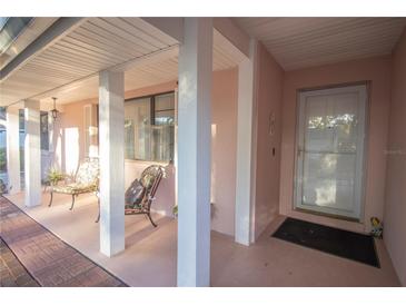 Inviting front porch with pink columns, chairs, and a welcoming entrance door at 613 Andrew St, Altamonte Springs, FL 32714