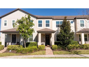 Charming townhome featuring well-maintained landscaping, a welcoming front porch, and neutral exterior paint at 9513 Amber Chestnut Way, Winter Garden, FL 34787