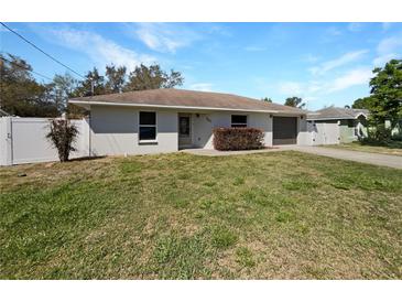 Charming single-story home featuring a well-maintained lawn and a classic exterior design at 760 Park Ave, Orange City, FL 32763