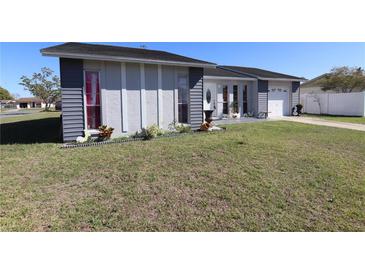 Charming single-Gathering home with a well-manicured lawn and inviting curb appeal at 763 Royal Palm Dr, Kissimmee, FL 34743