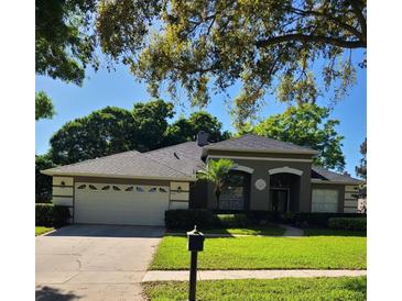 Charming single-story home with a well-manicured lawn and an attached two-car garage at 826 Chatfield Way, Lake Mary, FL 32746