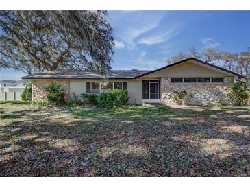 Charming single-story home featuring a stone facade and established landscaping at 120 Lake Dr, Oviedo, FL 32765