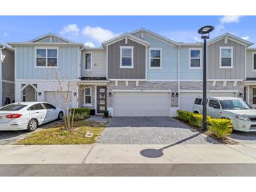 Charming townhome exterior with a paved driveway, colorful facade, and well-maintained landscaping at 1371 Captiva Cv, Sanford, FL 32771