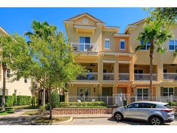 Charming townhome with balconies and lush landscaping, creating a warm and inviting curb appeal at 1447 Lake George Dr, Lake Mary, FL 32746