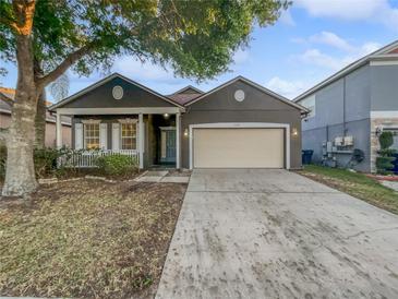 Charming single-story home featuring a two-car garage and well-maintained front yard at 1748 Ribbon Falls Pkwy, Orlando, FL 32824