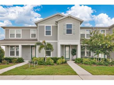 Charming townhome with well-maintained landscaping, complemented by blue skies and curb appeal at 11038 Leafshore Loop, Orlando, FL 32829
