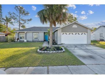 Charming single-story home with a well-manicured lawn and inviting blue front door at 2242 Dancy Trl, Clermont, FL 34714