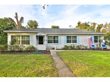 Charming single-story home with a well-manicured lawn and beautiful blue shutters at 2381 Roxbury Rd, Winter Park, FL 32789