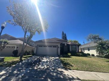 Charming single-story home with a two-car garage and well-maintained landscaping at 2625 Queen Mary Pl, Maitland, FL 32751