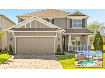 Charming two-story home with a gray facade, well-manicured lawn, and screened in pool at 432 Treasure Ln, Sanford, FL 32771