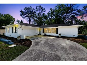 Charming white home with a well-manicured lawn and a spacious driveway at 1338 Franklin St, Altamonte Springs, FL 32701