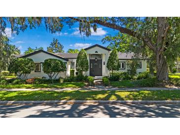 Charming home featuring manicured landscaping, and a striking, modern front door entrance at 1701 Palmer Ave, Winter Park, FL 32789