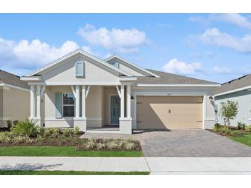 Charming single-story home with a well-manicured lawn, inviting porch, and a two-car garage at 2192 Seagrass Pt # 427, Kissimmee, FL 34747