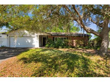 Charming single-story home with mature landscaping and a two-car garage at 4366 Roanne Dr, Orlando, FL 32817