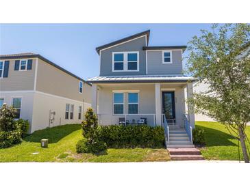 Charming two-story home featuring a covered porch and well-maintained landscaping at 4994 Citrus Leaf Blvd, Winter Garden, FL 34787