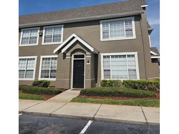 Charming two-story condo with a gable-roof entryway and well-maintained landscaping at 9141 Lee Vista Blvd # 308, Orlando, FL 32829