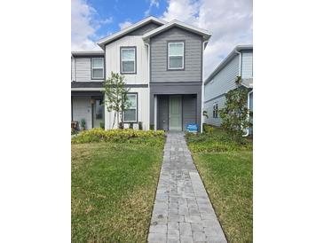 Charming two-story home featuring well-maintained landscaping and a welcoming front porch at 11151 Rising Sun St, Orlando, FL 32829