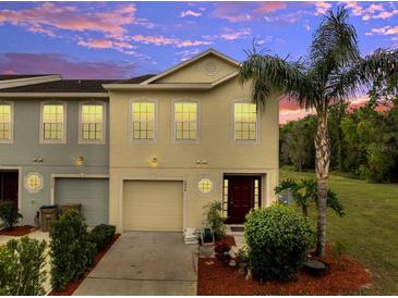 Charming two-story townhome with a well-manicured lawn and driveway leading to a one-car garage at 2906 Clarabelle Ct, Kissimmee, FL 34743