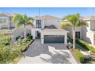 Stunning two-story home featuring a two-car garage, balcony, and landscaped front yard at 310 Pendant Ct, Kissimmee, FL 34747