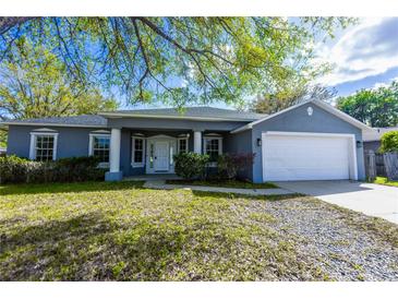 Charming single-story home with a well-manicured lawn and attached two-car garage at 3209 Hanley St, Deltona, FL 32738