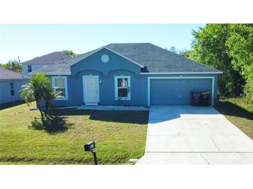 Charming single-story home with well-maintained lawn and attached two-car garage at 608 Robin Ln, Kissimmee, FL 34759