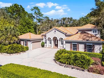 Charming home with a tile roof, manicured landscaping, and a spacious brick driveway at 8713 Shimmering Pine Pl, Sanford, FL 32771