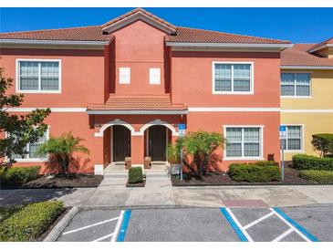 Inviting two-story townhome with colorful facade, landscaped grounds, and convenient accessible parking at 8845 Candy Palm Rd, Kissimmee, FL 34747