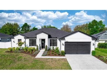 Charming single-story home with well-manicured landscaping, dark framed windows, and a welcoming front entrance at 2258 Ardon Ave, Orlando, FL 32833