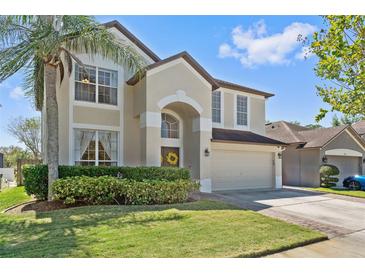 Two-story home with a two-car garage and lush landscaping in a desirable neighborhood at 848 Jadestone Cir, Orlando, FL 32828