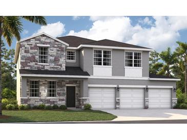 New two-story home featuring stone accents, a three-car garage, and professional landscaping at 1359 Wood Line Dr, Deland, FL 32720