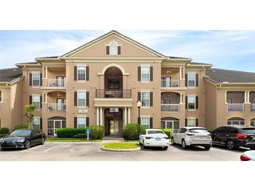 Attractive condo building with balconies, parking, and well maintained landscaping at 14316 Fredricksburg Dr # 507, Orlando, FL 32837