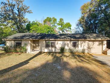 Charming single-story home featuring an attached garage, well-kept lawn and mature shade trees in a quiet location at 278 Silverstone Dr, Orange City, FL 32763
