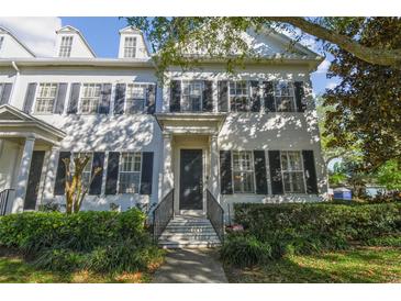 Charming two-story home with a beautiful lawn and dark shutters accenting the windows at 2827 Upper Park Road, Orlando, FL 32814