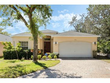 Charming single-story home with a well-manicured lawn, brick driveway and an attached two-car garage at 2933 Star Grass Pt, Oviedo, FL 32766