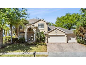 Beautiful two-story home with a three-car garage and a well-maintained lawn at 3344 Quailwest Ct, Orlando, FL 32812
